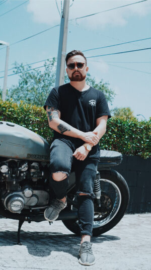 A man sitting on the back of his motorcycle.
