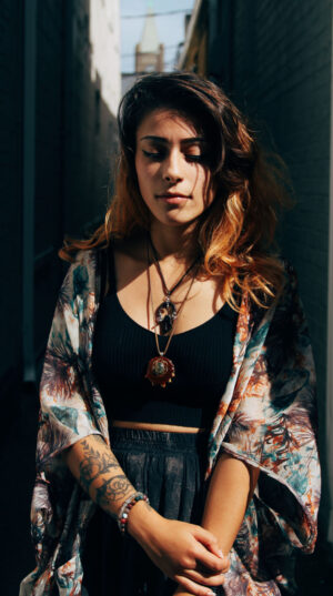 A woman with tattoos and a black top