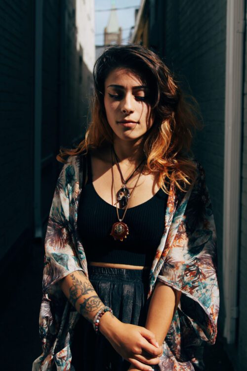 A woman with tattoos and a black top