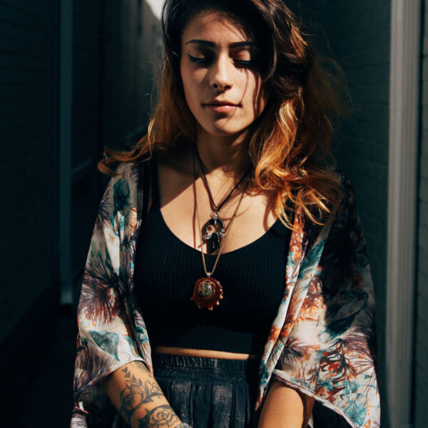 A woman with tattoos and a black top