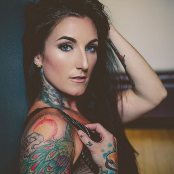 A woman with tattoos on her arms and shoulder.
