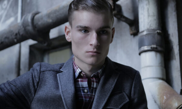 A man in a jacket and plaid shirt