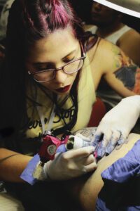 A woman with glasses is working on something
