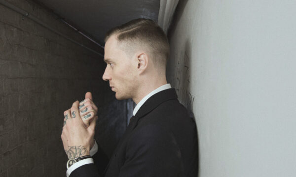A man in suit and tie holding a cell phone.
