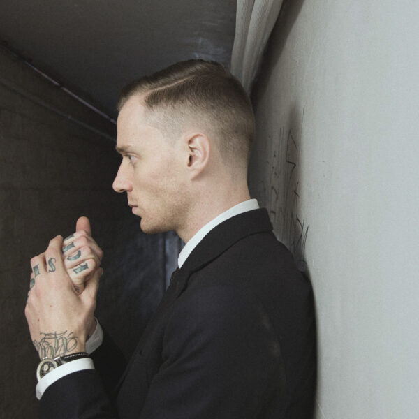A man in suit and tie holding a cell phone.