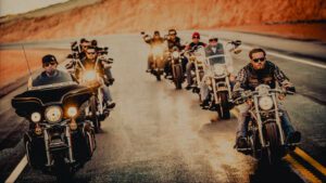 A group of people riding motorcycles down the road.