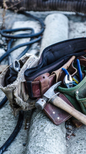 A bunch of tools in the bag on the ground