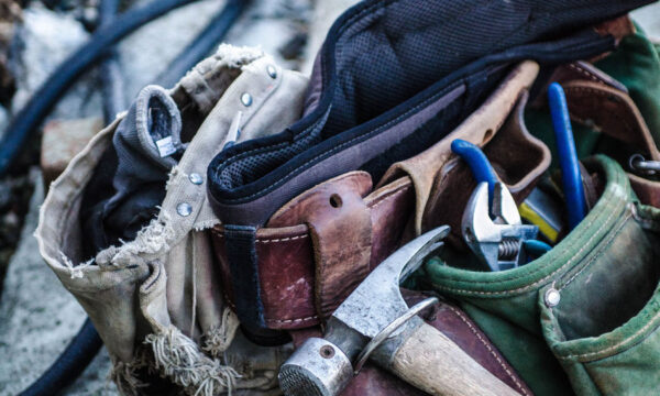 A bunch of tools in the bag on the ground