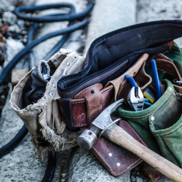 A bunch of tools in the bag on the ground