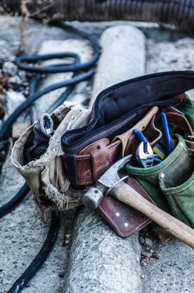 A bunch of tools in the bag on the ground