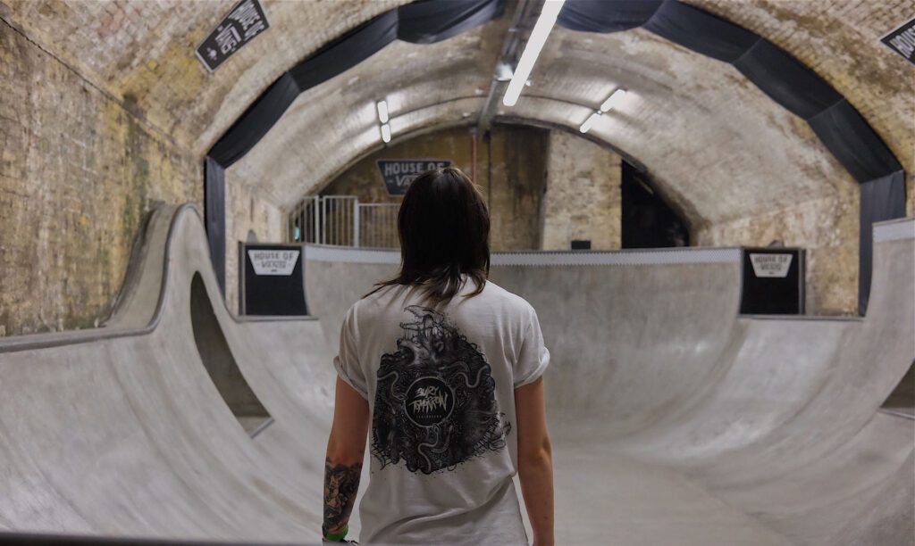 A person in a skate park with their back turned.